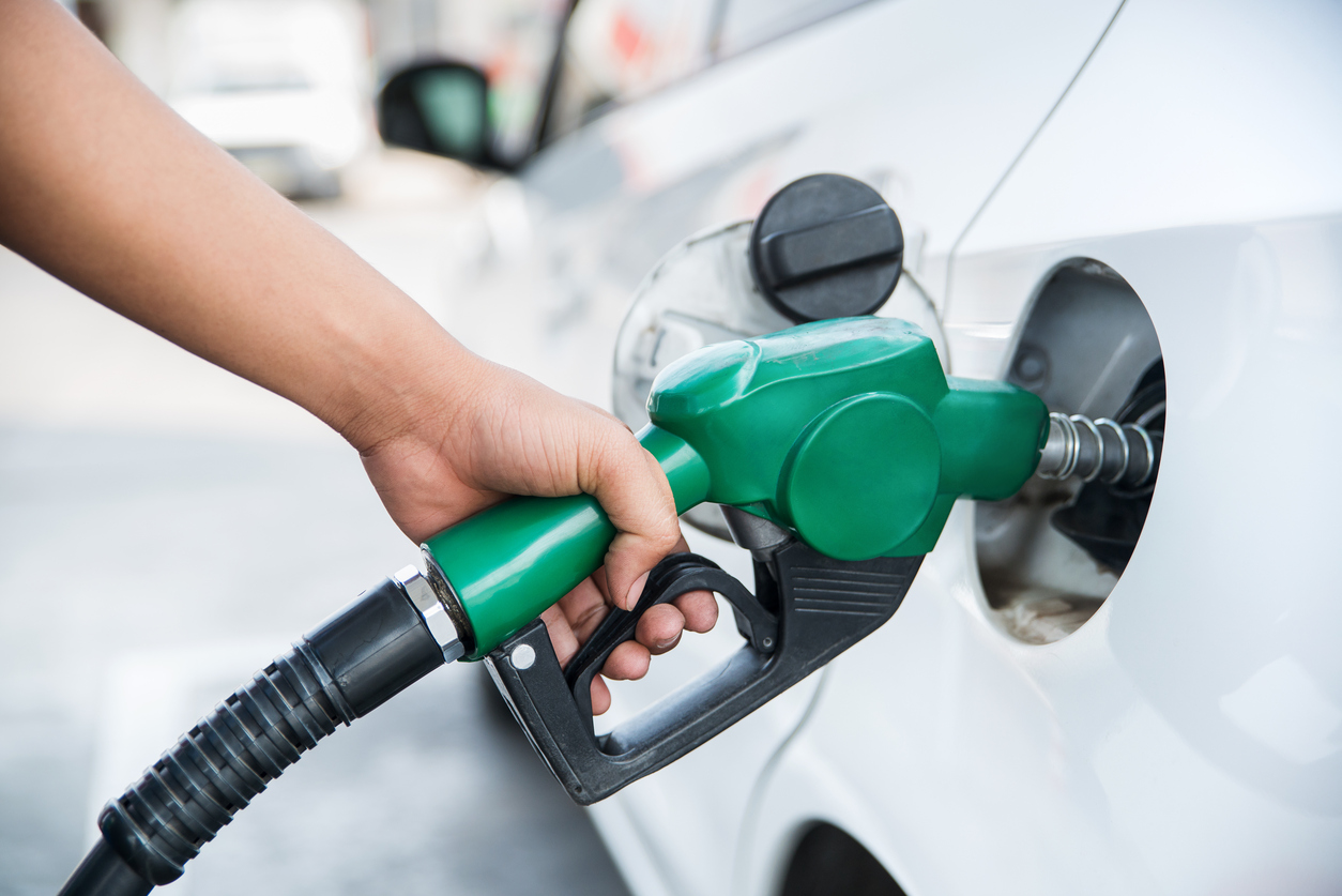 Woman refueling car.