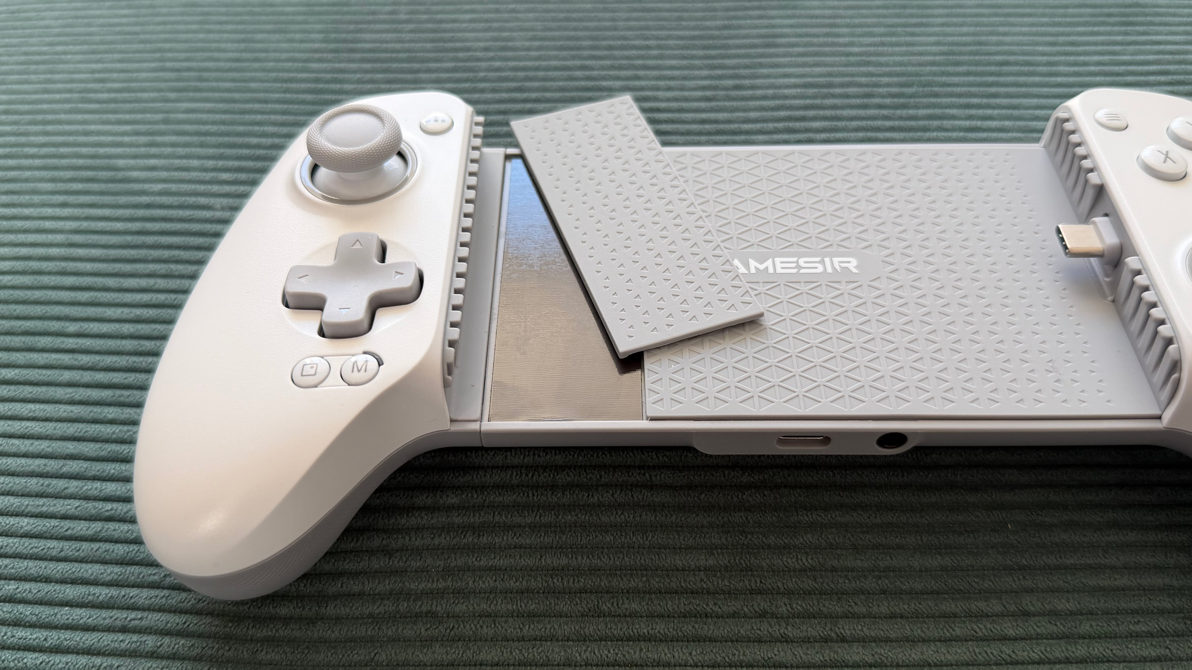 The GameSir G8+ MFi mobile controller on a green surface
