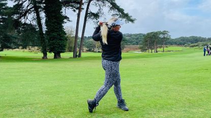 Carly Frost hitting a fairway wood