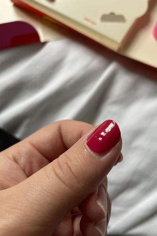 Valeza showing her thumb with a Glaize nail sticker freshly applied