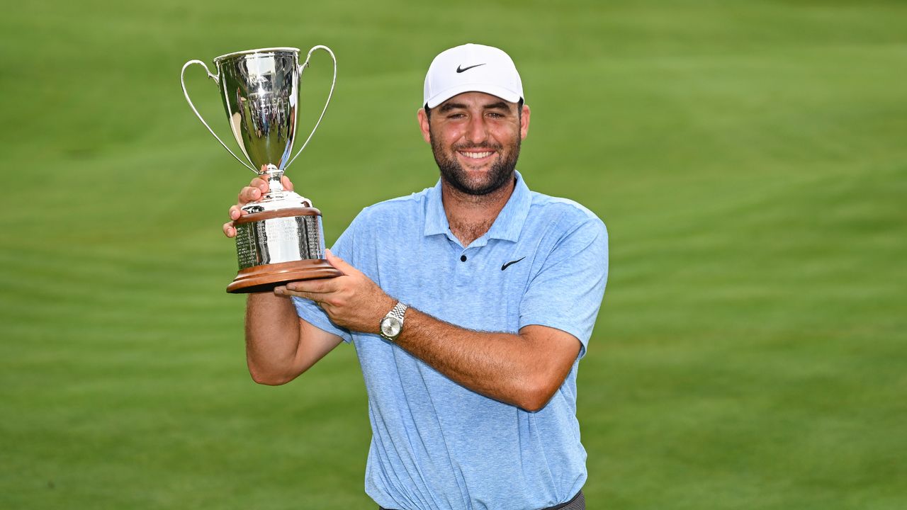 Scottie Scheffler poses with the Travelers Championship trophy