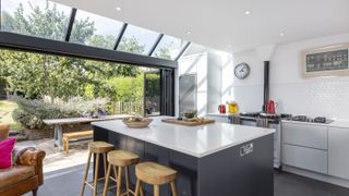 black kitchen island in glass extended kitchen 