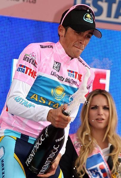 Alberto Contador prepares the spray of champagne.