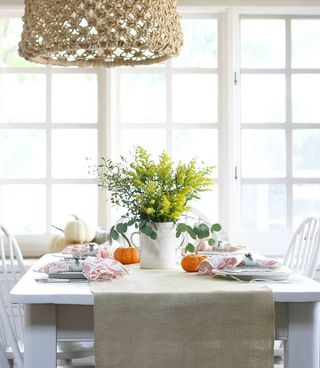 white dining room with window and simple tablescape