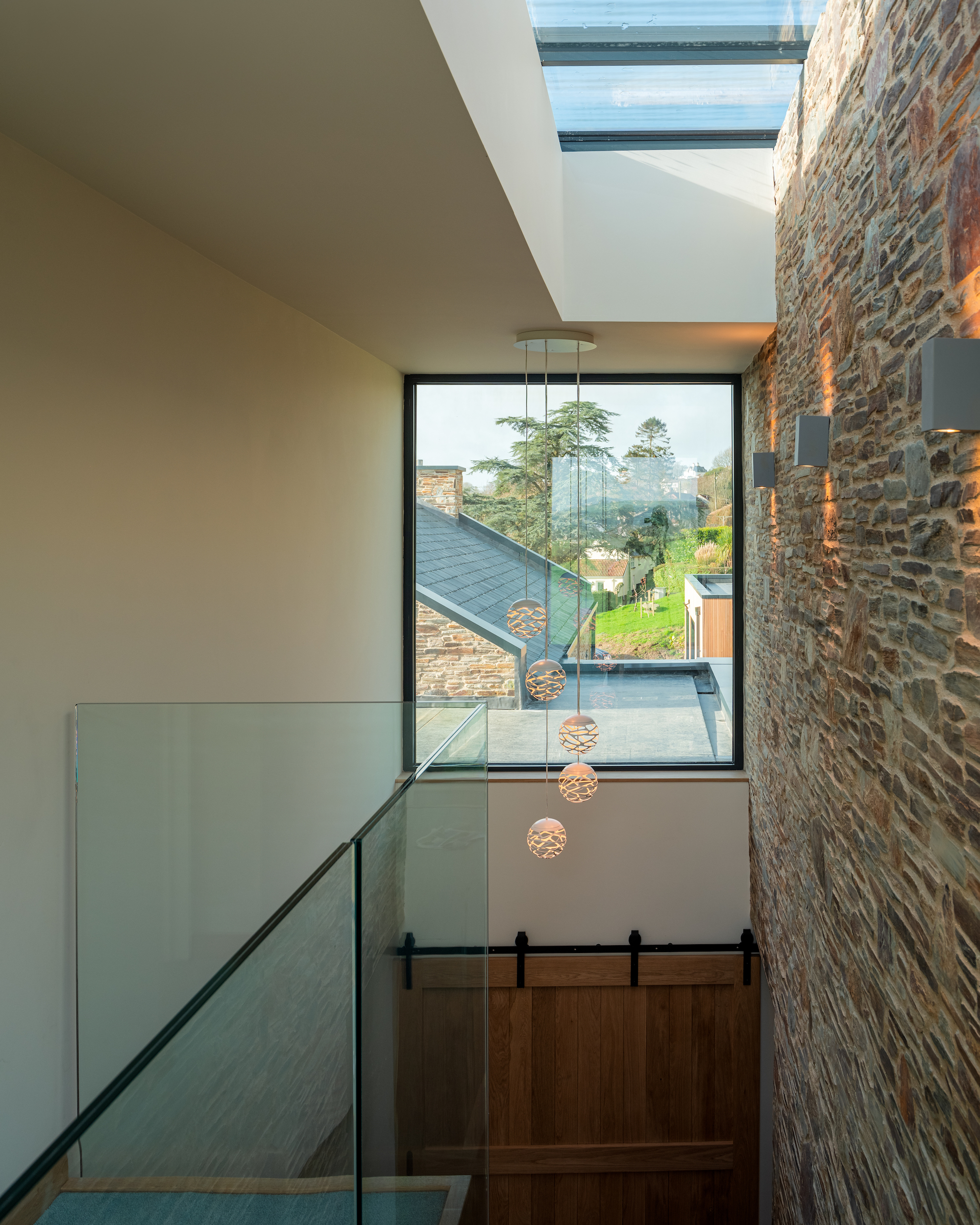 pendant lighting and stone cladding in hallway staircase