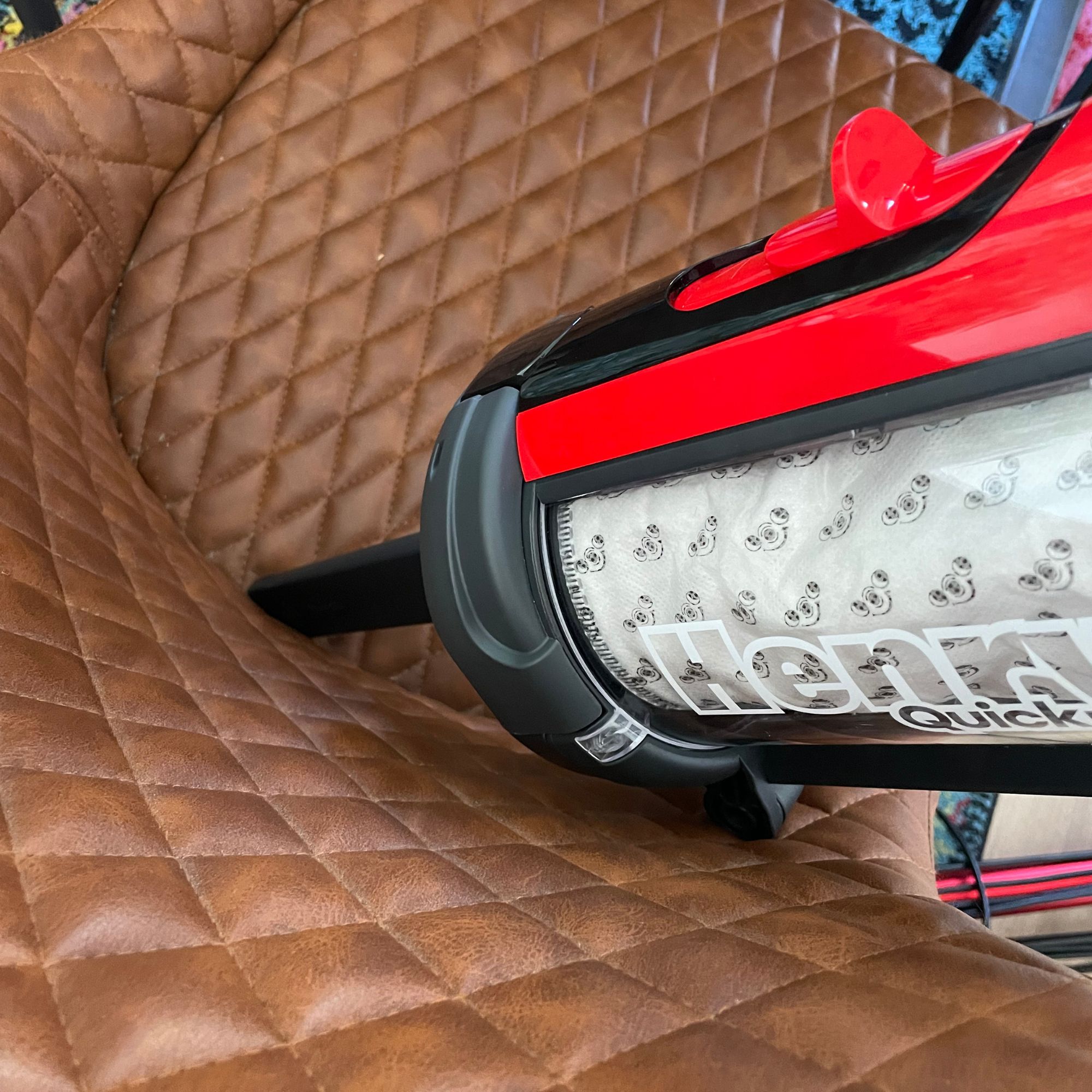 Using the crevice nozzle of the Henry Quick Corded Vacuum Cleaner to clean leather dining chairs