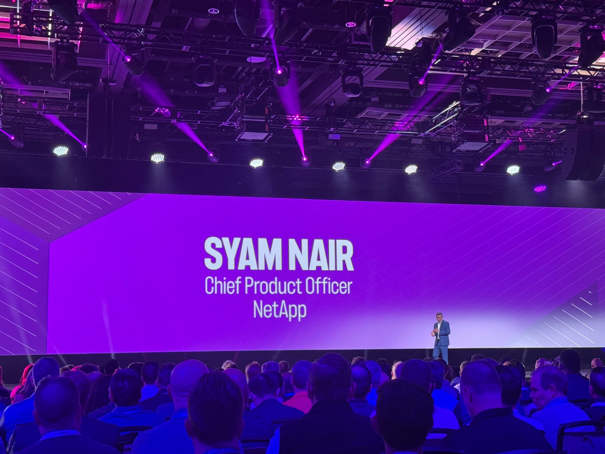 NetApp chief product officer Syam Nair pictured on stage at NetApp Insight 2026.
