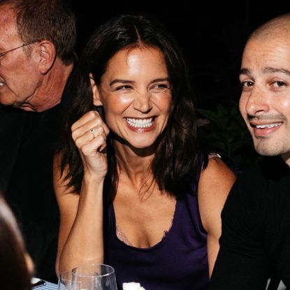 Katie Holmes wearing a purple dress and red shoes at the Michael Kors 45th Anniversary Collection Dinner held at Swifty's at The Hedges Inn on August 20, 2026 in East Hampton, New York
