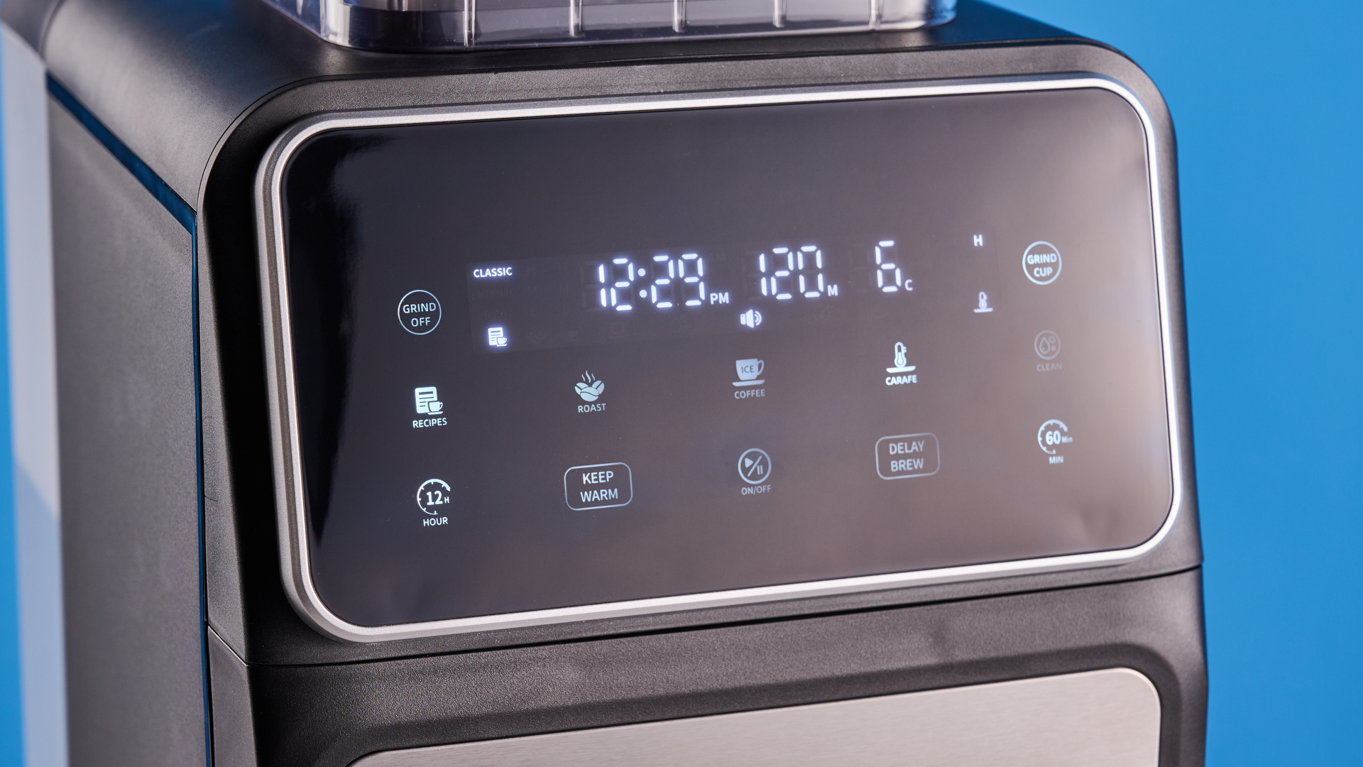 the gevi 10-cup drip coffee maker with grinder photographed against a blue background, showing the glass carafe, water tank, touch screen, and accessories including plastic filter