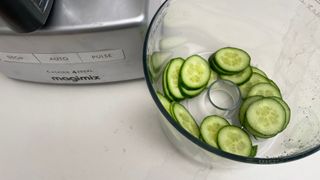The Magimix 4200XL being used to slice cucumber