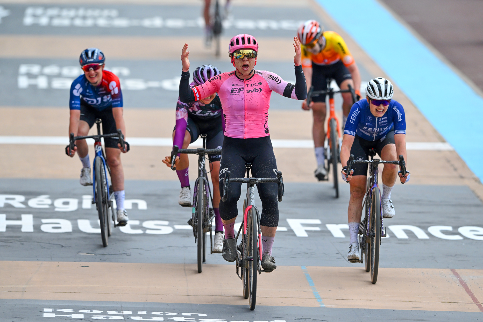 Alison Jackson (EF-Tibco-SVB) appears shocked as she celebrates victory from a seven-rider group on the velodrome at the 2023 Paris-Roubaix Femmes