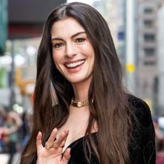 Anne Hathaway wore a vintage Gianni Versace couture little black dress to the Late Show With Stephen Colbert