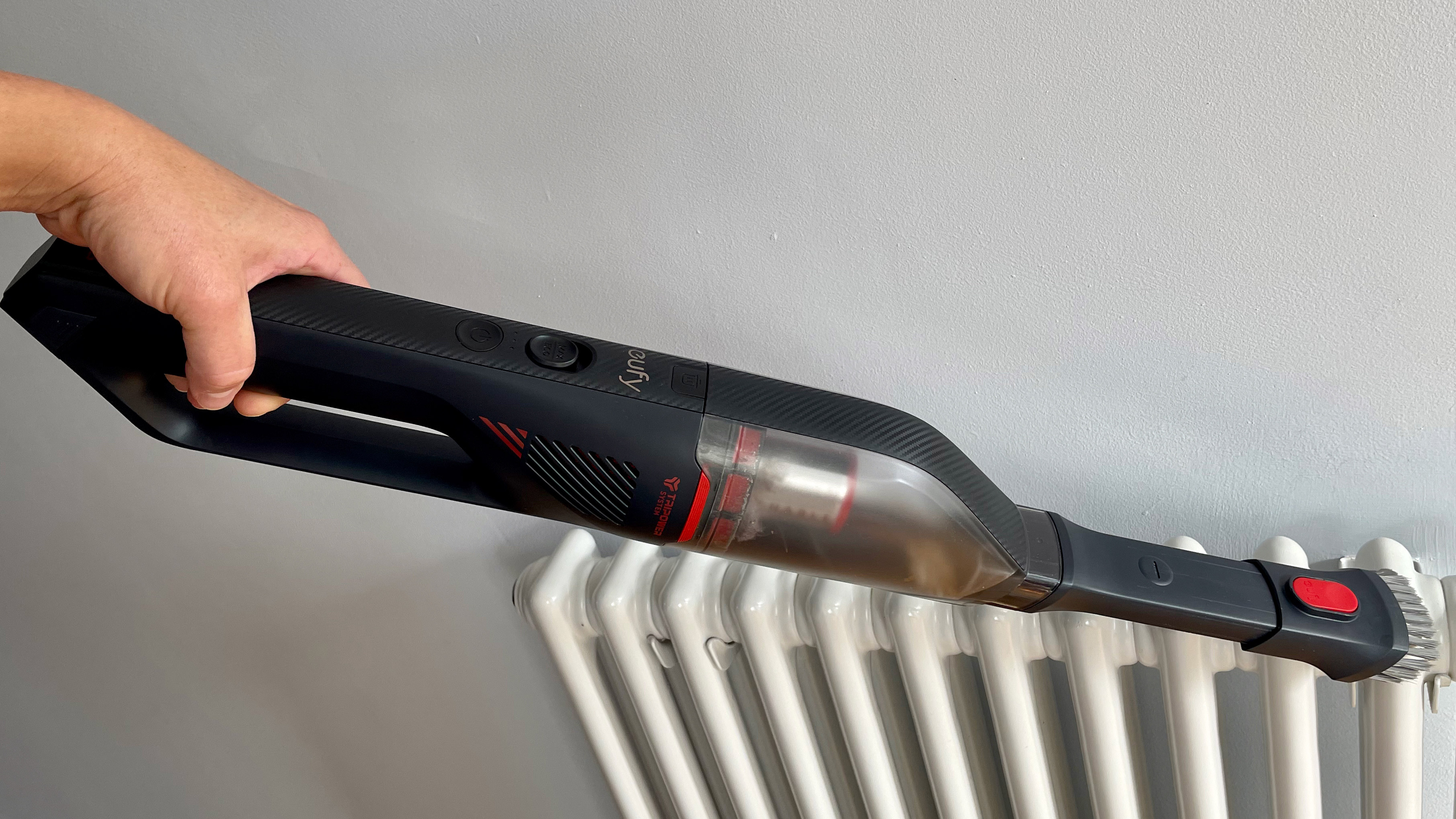 The Eufy HomeVac H30 Mate being used to clean dust from a radiator