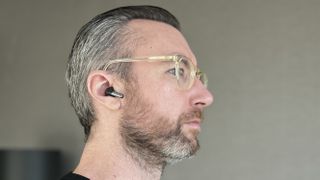 OnePlus Buds Pro 2 worn by a man looking to the right