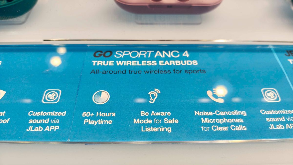 JLab's new earbuds at IFA, on a blue table
