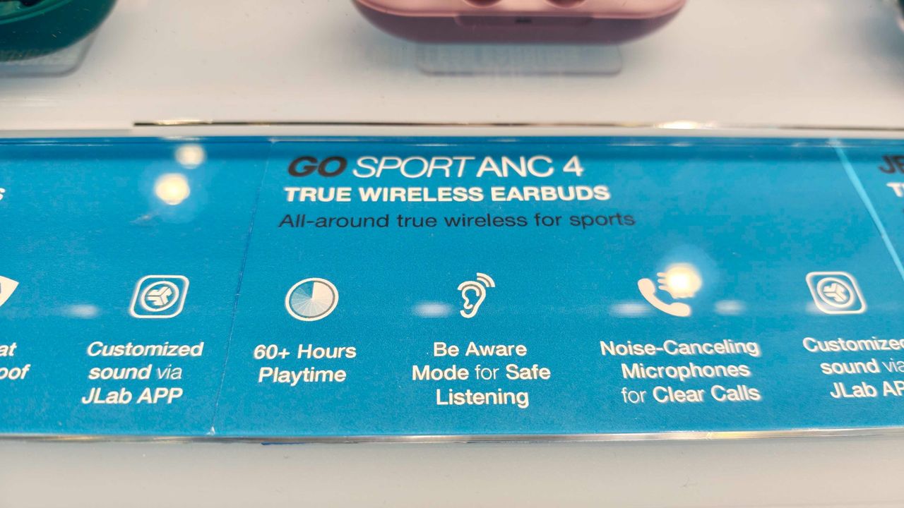 JLab's new earbuds at IFA, on a blue table