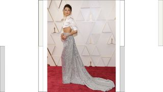 Zendaya wears a white silk crop top and sparkly grey skirt attends the 94th Annual Academy Awards at Hollywood and Highland on March 27, 2022 in Hollywood, California.