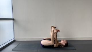 Kelly Turner demonstrates happy baby yoga pose