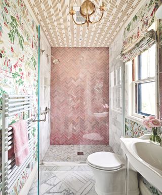 pink tiled bathroom with floral wallpaper