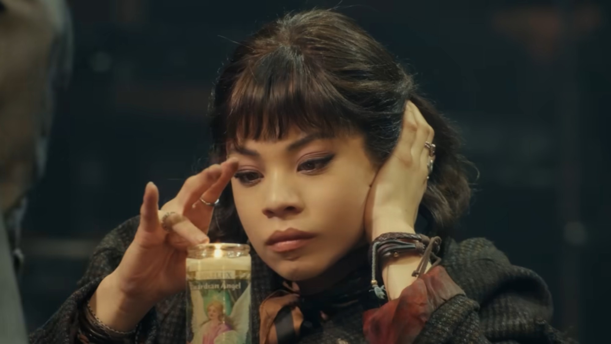 Eva Noblezada touching a candel in Hadestown.