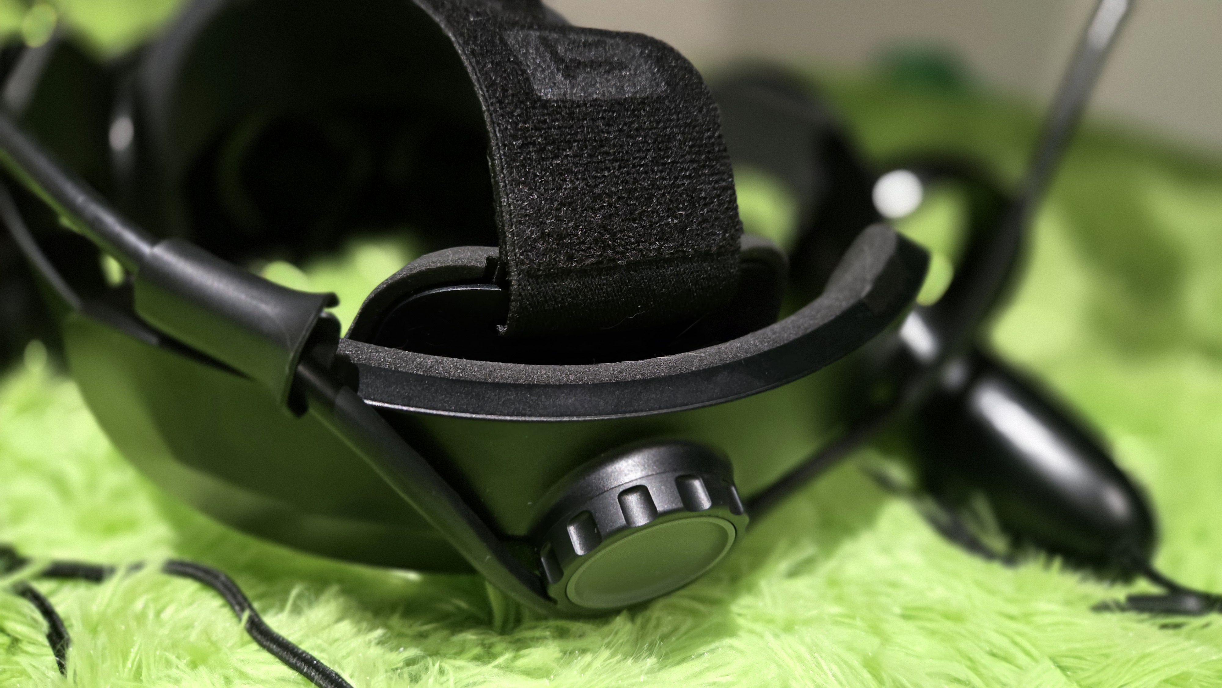 A Pimax Crystal Super virtual reality headset on a green background.