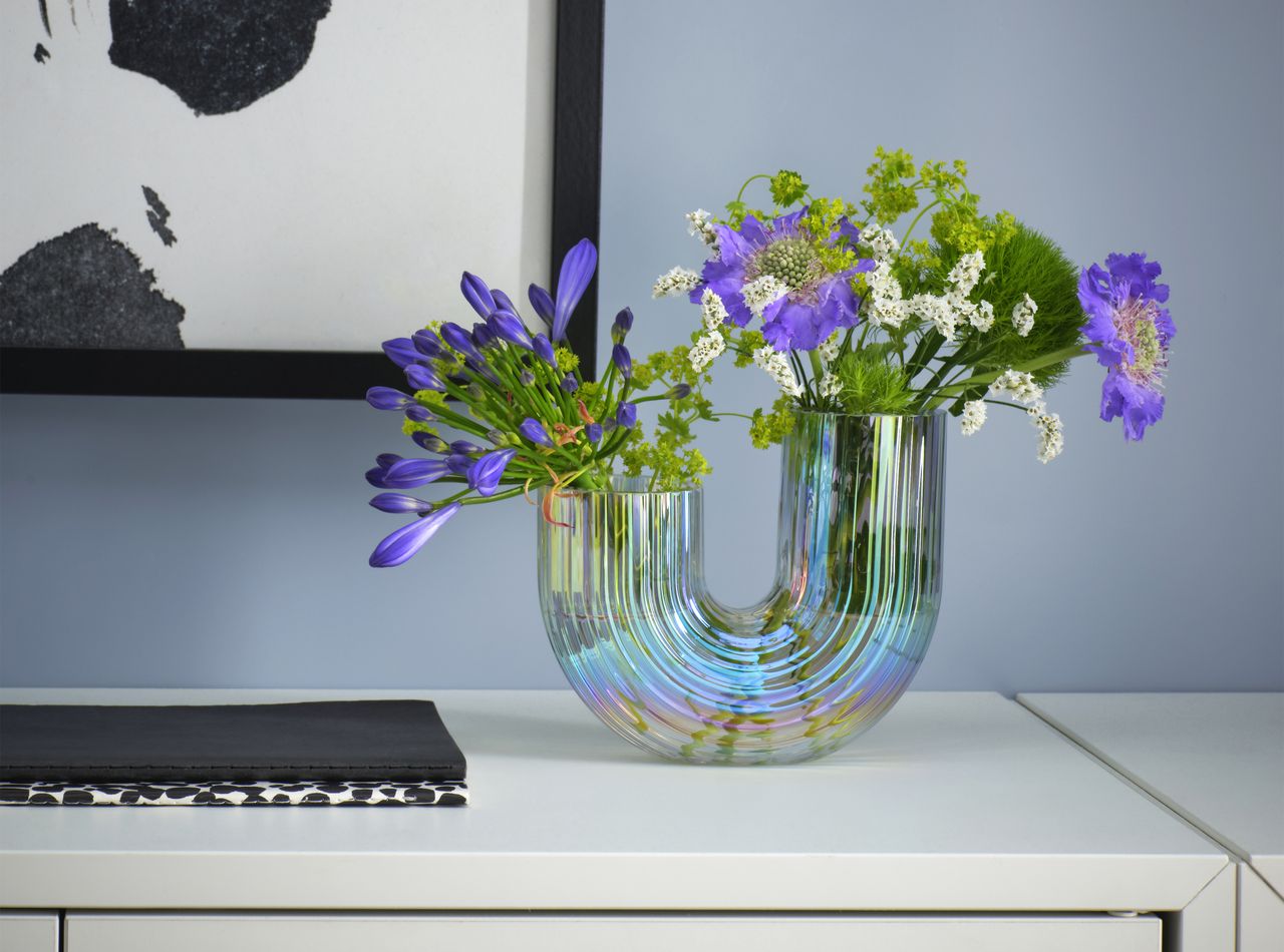 A mother of pearl effect vase on a side table