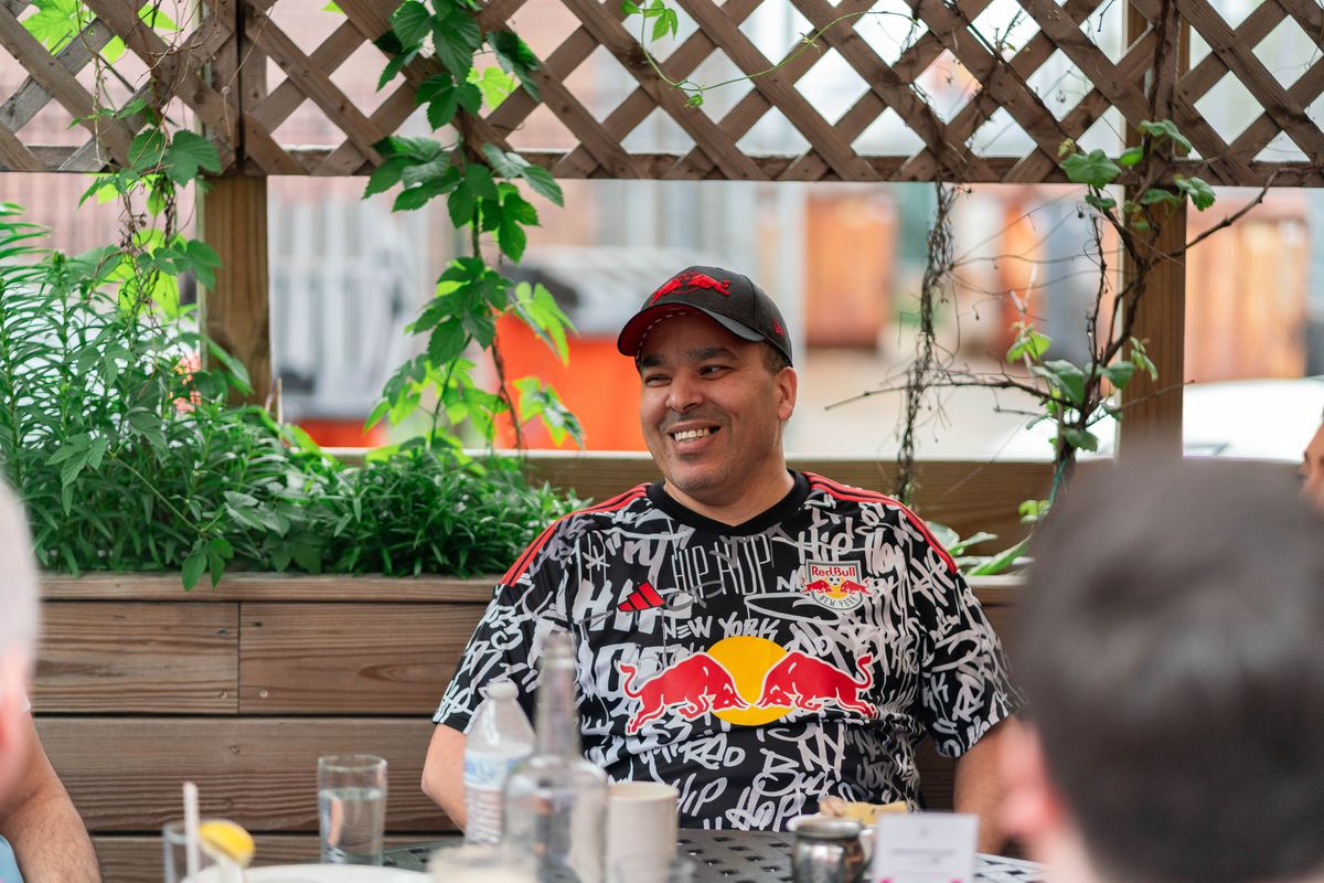 New York Red Bulls fan Vic Arroyo smiles outside a restaurant in Queens