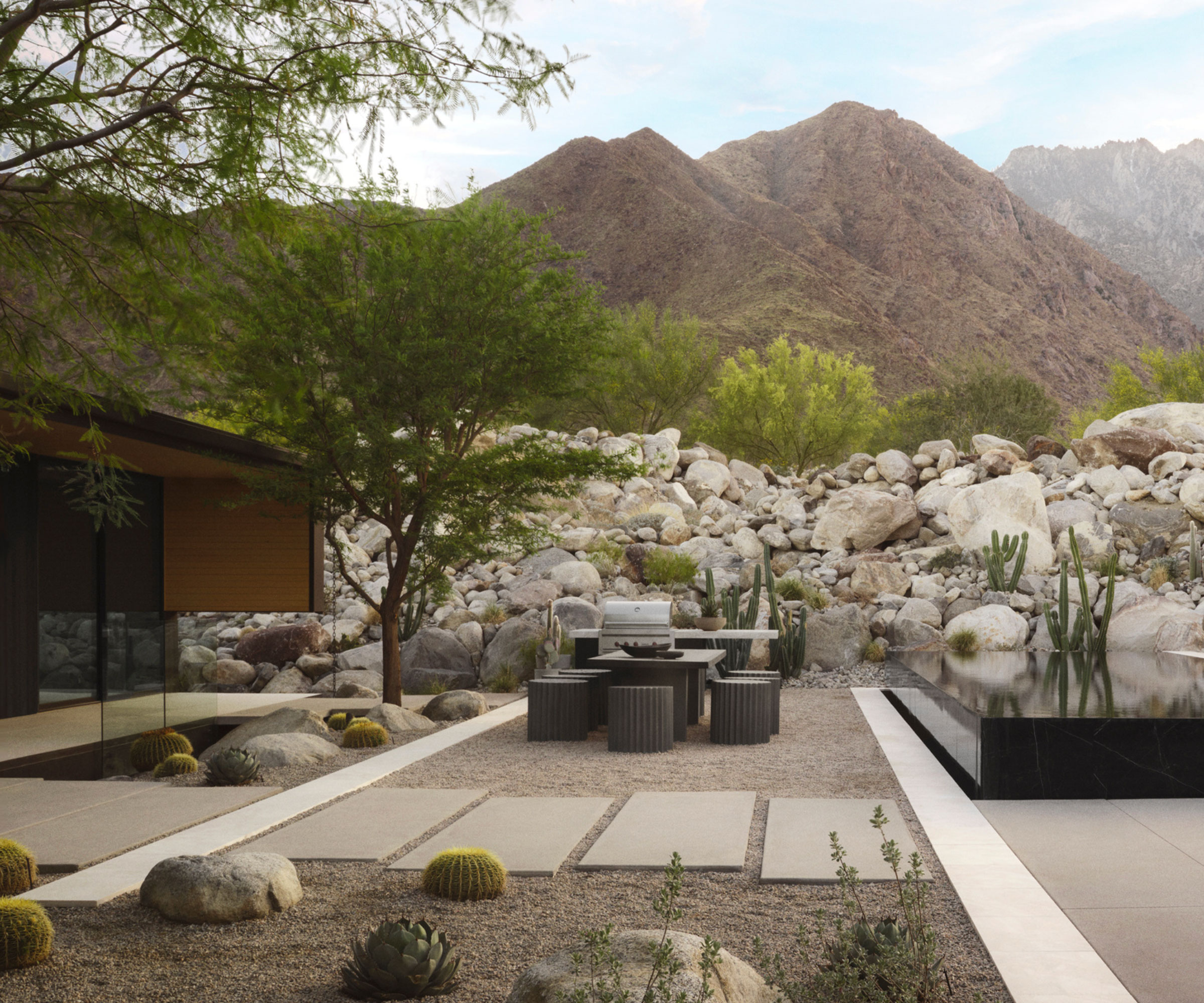 desert modernist design with boulders, gravel, plats and outdoor furniture