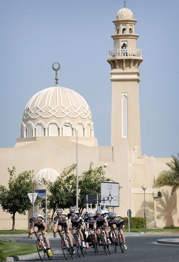Topsport Vlaanderen make their way beneath the distinctive architecture of the Middle East