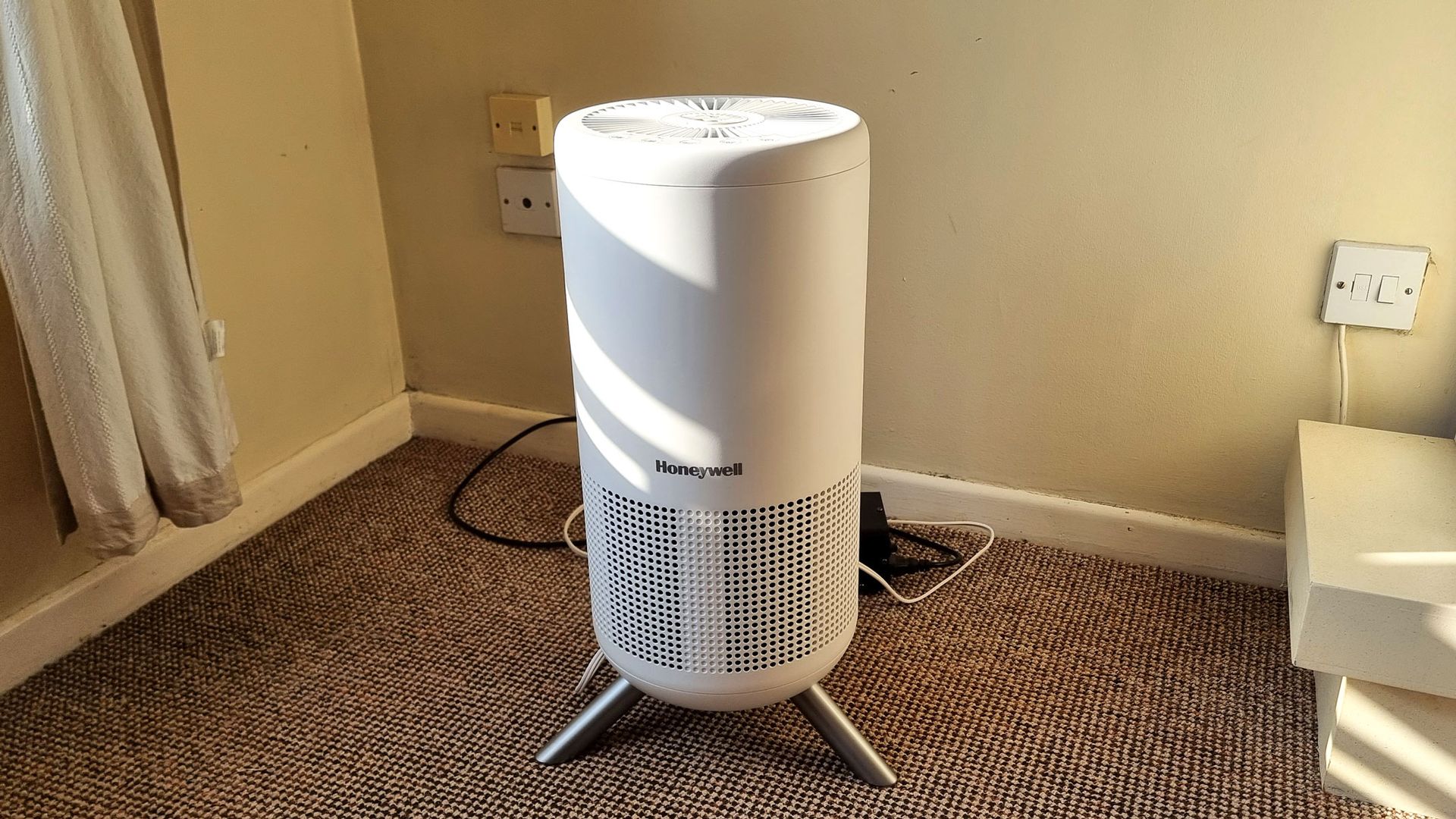 a close-up picture of the Honeywell Designer Series air purifier standing in a corner of a sunlit room