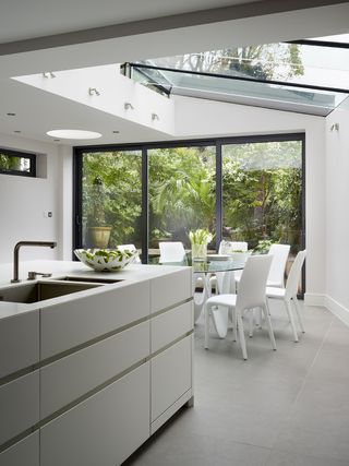 glass box extensions with a white kitchen