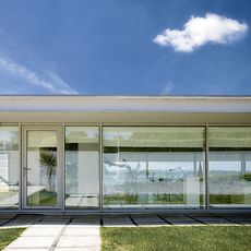 exterior of house with glass wall and grass