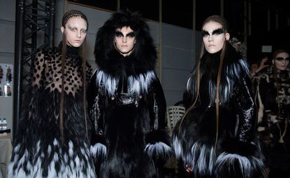 Three models backstage at Alexander McQueen A/W 2014