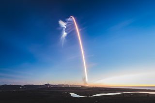 A SpaceX Falcon 9 rocket streaks into space carrying 10 Iridium Next communications satellites in this long-exposure view of the launch from Vandenberg Air Force Base in California on Dec. 22, 2017.