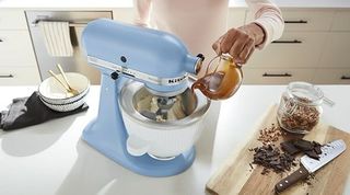 Blue KitchenAid standing mixer with Ice cream attachment in a kitchen setting