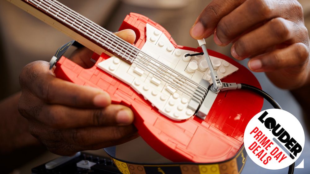 Hands holding red Lego Fender Stratocaster