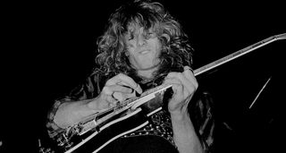 John Sykes solos on his Gibson Les Paul Custom and it looks like he might even be two-hand tapping – this was the '80s, and this black-and-white image captures him in action on Whitesnake's 1984 tour in Chicago.