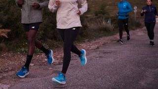 4 people running wearing New Balance trainers and workout gear