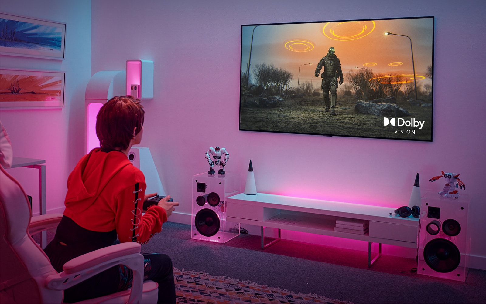 Image showing a gamer playing on an LG TV in a pink-lit living room