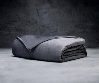 Luxome Weighted Blanket in Gray against a gray background.
