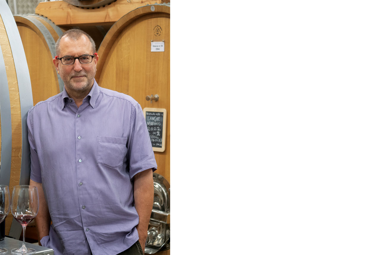 Alan Manley standing in front of barrels