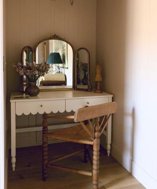dressing table with scallopped edge and three legged chair with bobbin detail on legs. A stand alone antique mirror