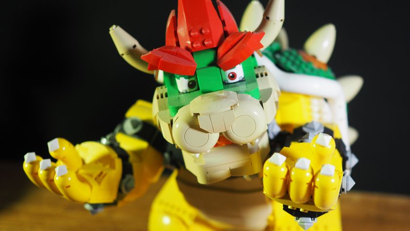 Lego The Mighty Bowser on a wooden table with his hands in the air