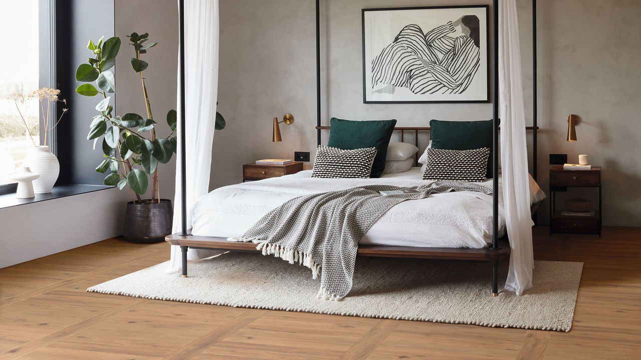 Bedroom with low height, four-poster double bed on wooden LVT flooring