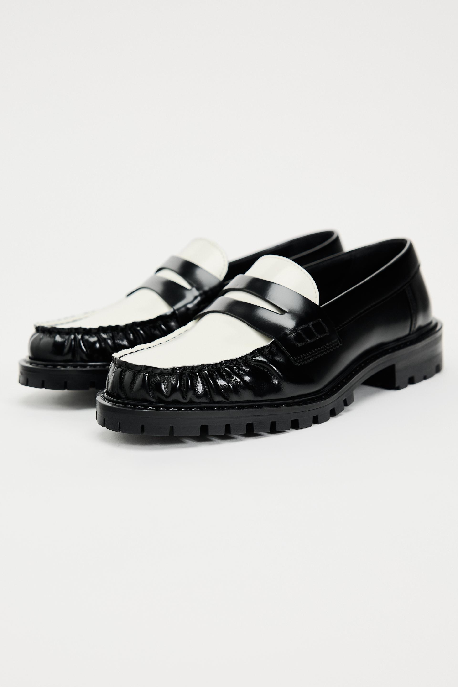 black and white leather penny loafers for women with lug soles