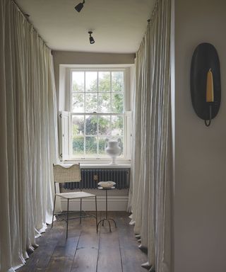 dressing room with shelving concealed behind white linen drapes