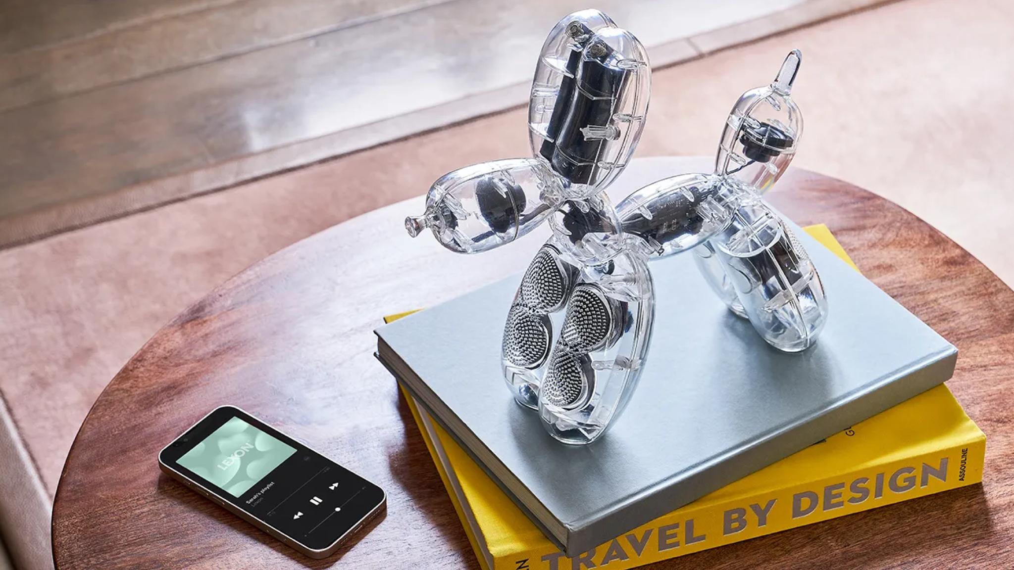 Lexon Balloon Dog Speaker on top of a stack of books with an MP3 player next to it