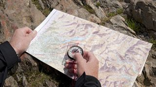 man holding a map and compass