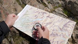 Man holding a map and compass