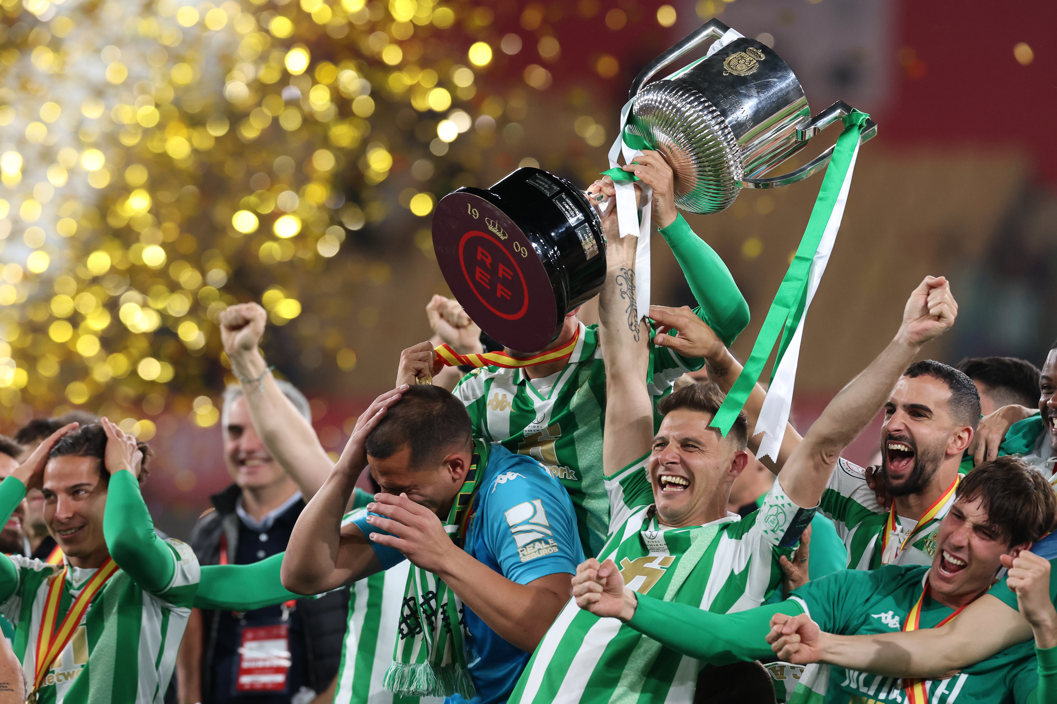 Real Betis players celebrate with the Copa del Rey after victory against Valencia in the final in April 2022.